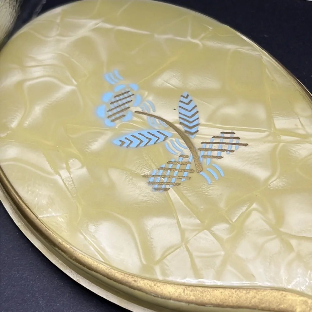 Vintage yellow celluloid vanity mirror, comb and brush set